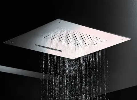 Eine moderne Regendusche, die in eine dunkle Decke eingebaut ist, lässt gleichmäßige Wasserströme herabfallen.
