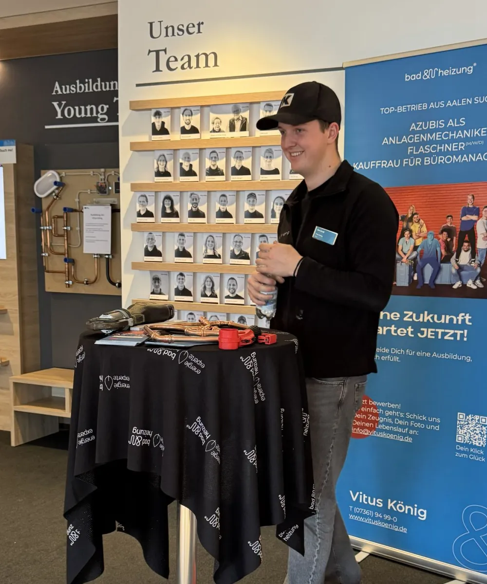 Ein Auszubildender der Firma Vitus König steht am Infostand im Firmengebäude.
